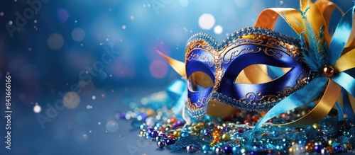Mardi Gras carnival masquerade mask on blue background with confetti copy space New Orleans carnival Mardi Gras day party bright festive decor Invitation banner card poster flyer