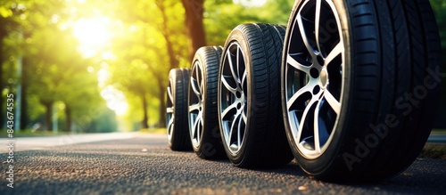 Four summer tire on road Change tyre 4 wheel off on nature in blurred background Advertise banner with copy space