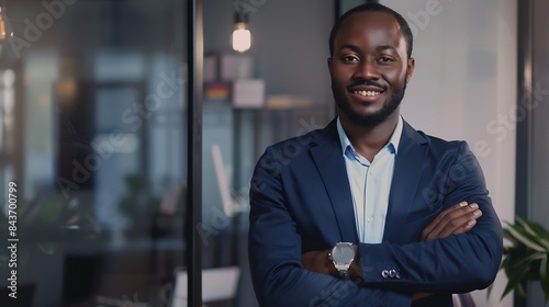 Portrait of smiling african businessman standing in office with crossing hands : Generative AI