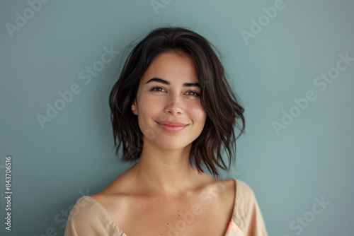 A close up portrait of a young woman with a subtle smile