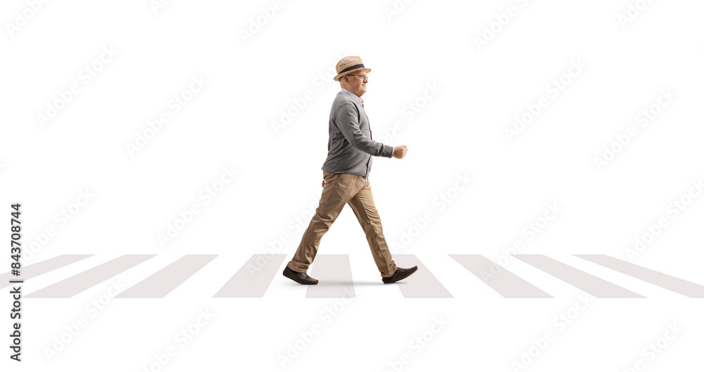 Full length profile shot of an elderly gentleman walking at a pedestrian crossing Full length profile shot of an elderly gentleman walking at a pedestrian crossing
