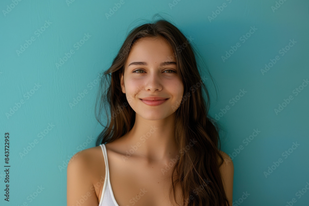 A close up portrait of a young woman with a subtle smile A close up portrait of a young woman with a subtle smile