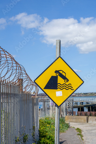 Road sign - car falling in water