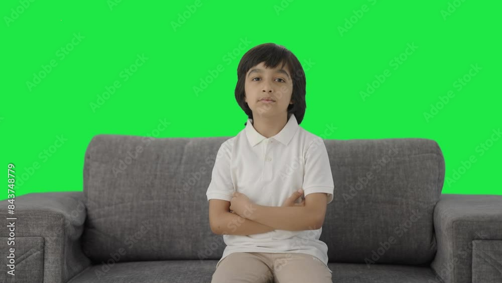 Serious Indian boy looking at the camera Green screen Serious Indian boy looking at the camera Green screen