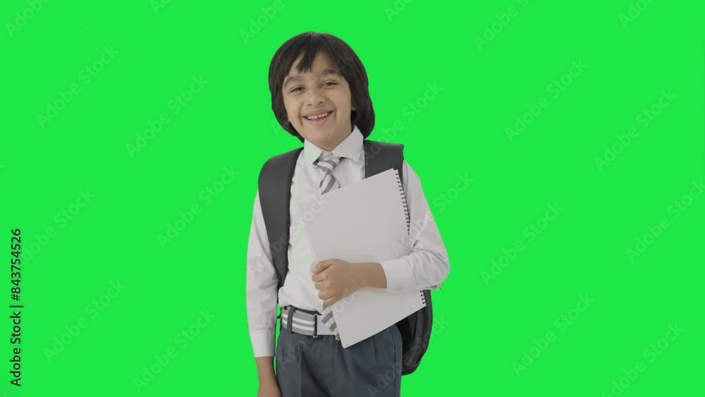 Happy Indian school boy standing with books Green screen Happy Indian school boy standing with books Green screen