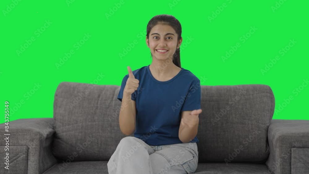 Happy Indian teenage girl showing thumbs up Green screen