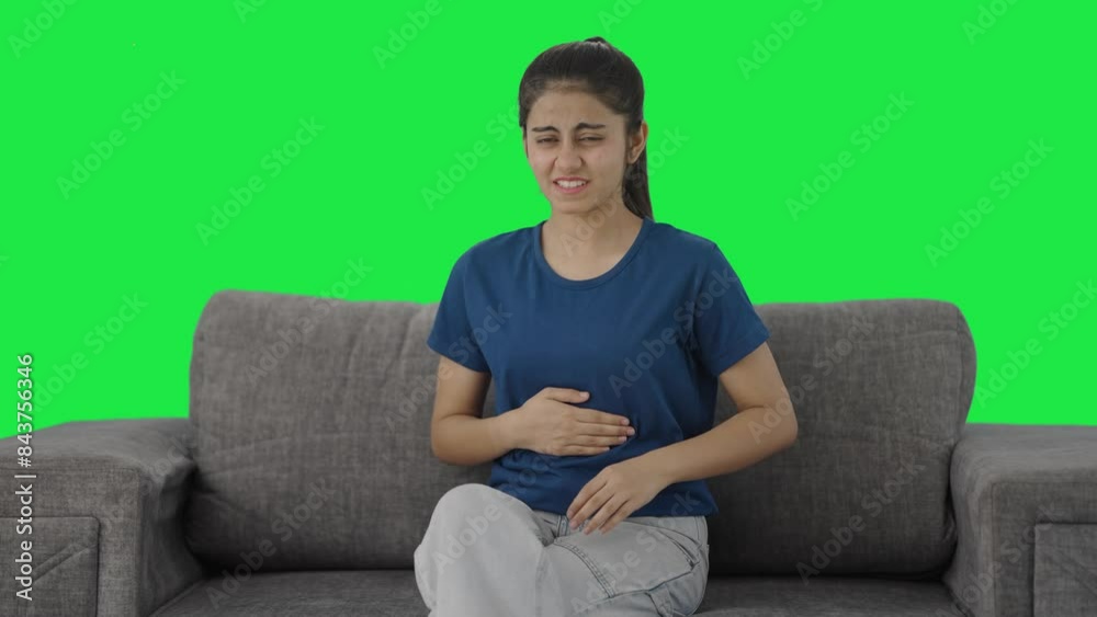 Indian teenage girl suffering from stomach pain Green screen Indian teenage girl suffering from stomach pain Green screen