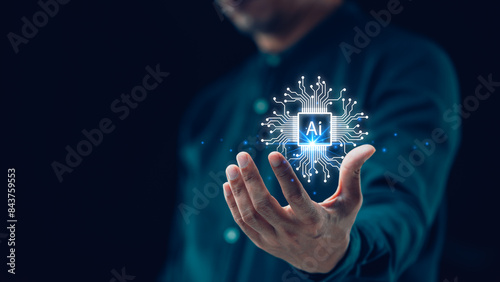 Artificial intelligence and automated machine learning are featured in a blue digital user interface with a businessman’s hand in the background. Key concepts of industrial business.