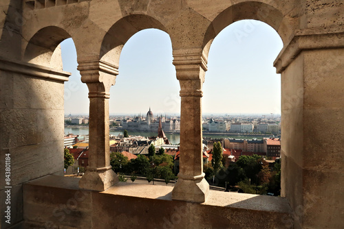View through a stone window of the Fisherman s Bastion onto the Hungarian Parliament Building at the Danube River  Budapest  Hungary