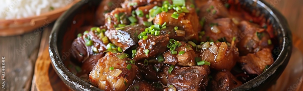 Bowl of food with meat and rice on a table, filipino recipes Bowl of food with meat and rice on a table, filipino recipes