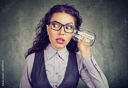 Funny looking woman listening to a secret conversation