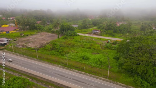 Raub, Pahang - March 6, 2023 Aerial view of the foggy village near Masjid Al Maaruf Kg Durian Sebatang in the morning. 4K photo