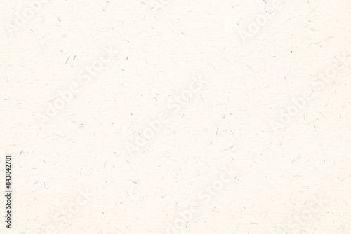 A close-up image of beige paper with visible recycling inclusions. The paper has a textured surface, and the inclusions appear as small, irregular specks.