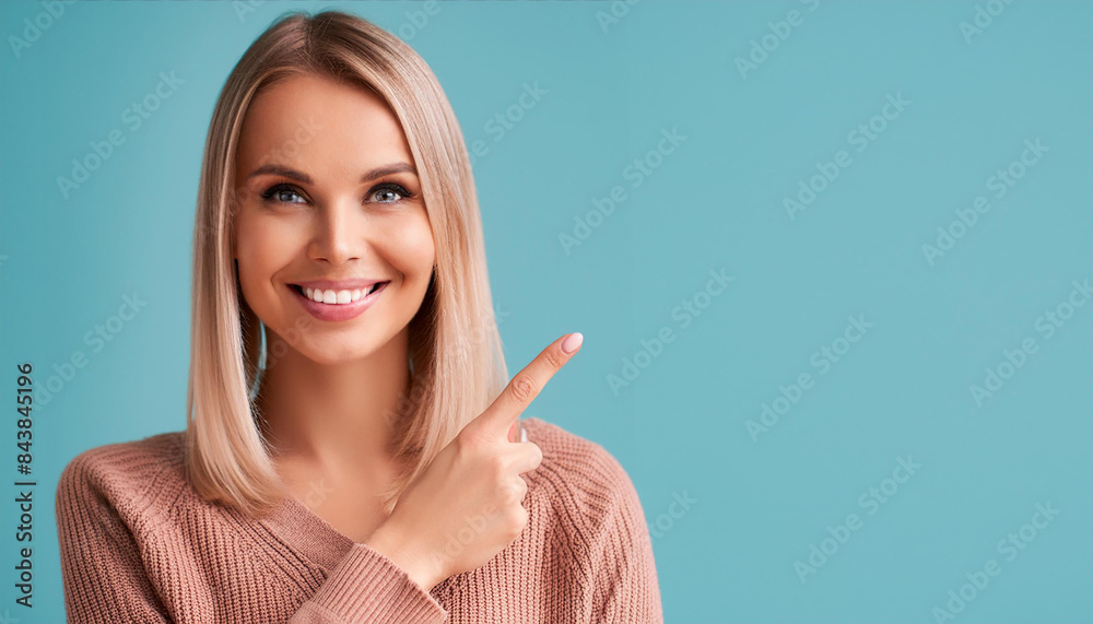 Woman holds finger pointed on empty copy space background. Happy adult person pointing away at blue copy space for advertisement. Woman holds finger pointed on empty copy space background. Happy adult person pointing away at blue copy space for advertisement.