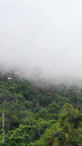 Landscape Green nature of Green Mountain with Traditional Thai House Little village seen at Doi Sakad Pua  Nan Thailand in Rainy Season in the morning  photo