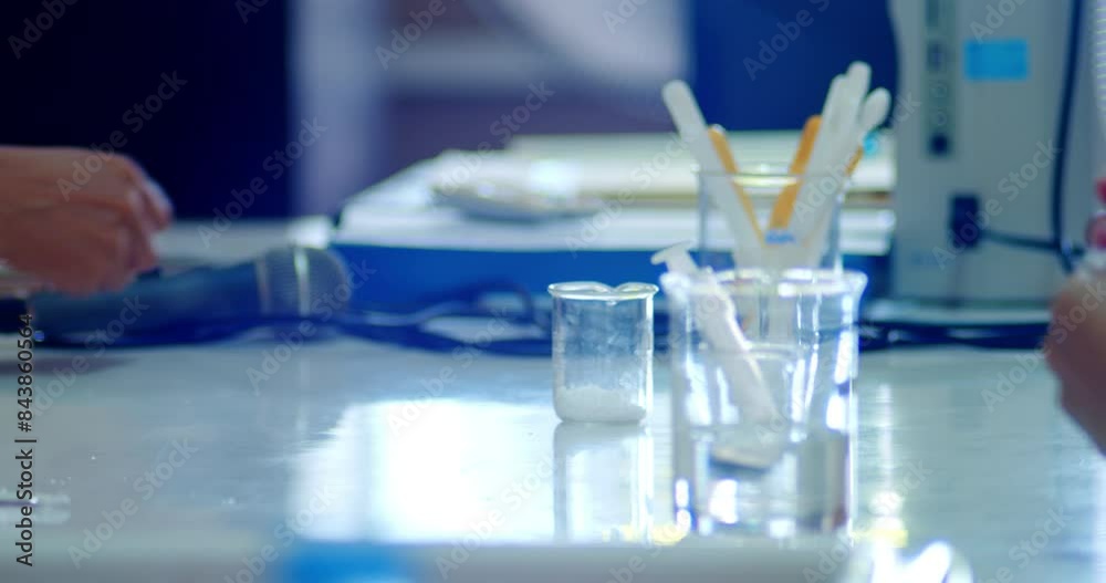Scientific experimental study of chemistry on the topic of saturated solutions in a class of Asian high school students in white school uniforms in a science laboratory.