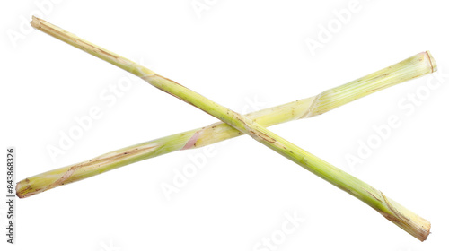 Two stalks of lemongrass crossed over each other, isolated on a black background.