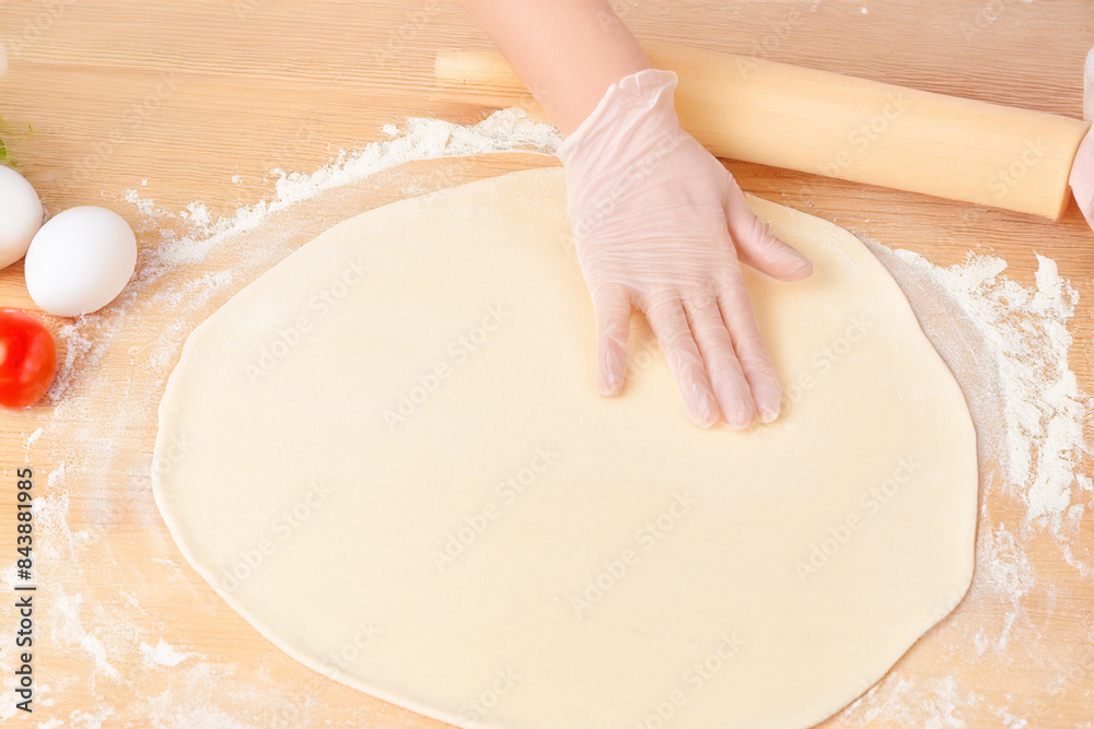 use of rolling pin to prepare pizza dough