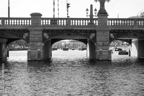 a bridge over a canal in black and white
