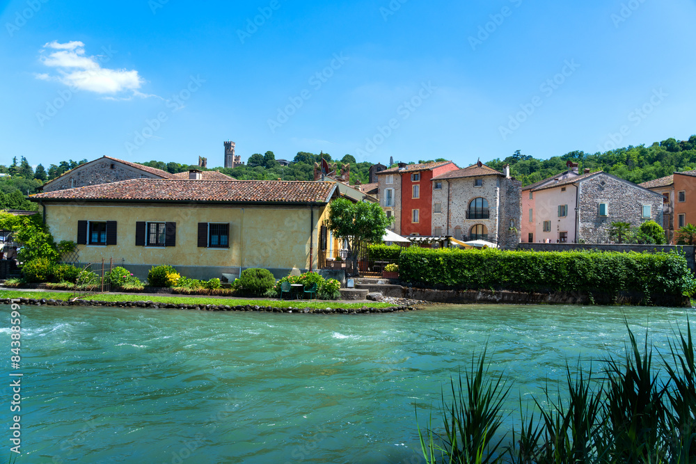 Obraz premium the charming, colourful village of Borghetto sul Mincio in the province of Verona, lying on the turquoise waters of the River Mincio