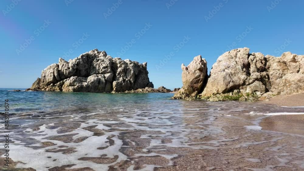 Beautiful sea view on an empty rocky beach with blue sky in Spain, 4K Beautiful sea view on an empty rocky beach with blue sky in Spain, 4K