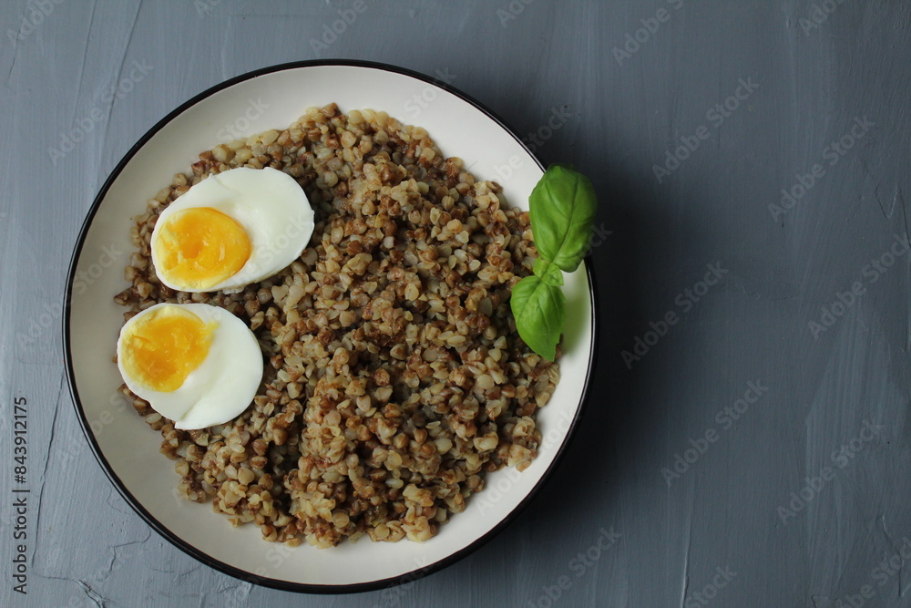 Buckwheat porridge with chicken egg, basil, top view. The concept of healthy food Buckwheat porridge with chicken egg, basil, top view. The concept of healthy food