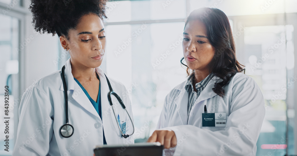 © peopleimages.com - Women, doctors and explain on tablet in hospital for patient information, appointment and schedule. Database, medical and healthcare practitioner with technology for telehealth, service and medicine