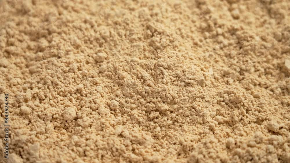 Peanut flour falling in slow motion. Gluten free baking nut powder is a versatile ingredient for baking. Rotation Peanut flour falling in slow motion. Gluten free baking nut powder is a versatile ingredient for baking. Rotation