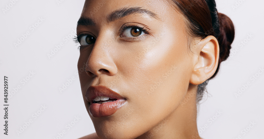 Fototapeta premium Studio, shine and face of woman, makeup and results of treatment, soft and confidence for glow or beauty. Pink background, portrait and pride of skin, dermatology and cosmetics for person or skincare