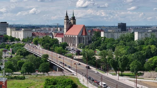 Flight from right to left side. new flow bridge, river elbe and johannis church in magdeburg. traffic on the bridge after construction site. photo