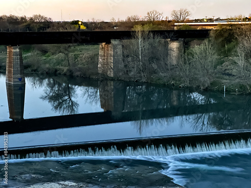 reflections on the flowing waters of the river below