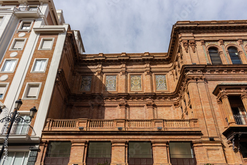 Obraz na płótnie Seville, Spain, September 12, 2021: The Coliseum building, Edificio Coliseo, a former theater and now office building located on Constitution Avenue. w salonie