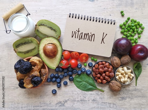 Vitamin K rich foods. High vitamin K foods. Natural dietary sources of vitamin K include dried fruit, leafy green vegetable, nuts, peas. Vitamin K helps build strong bones and regulate blood clotting. photo