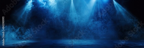 empty stage with spot light and smoke in blue hue on dark background