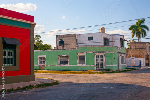 Small pastel colored colonial house with a washed out facade photo