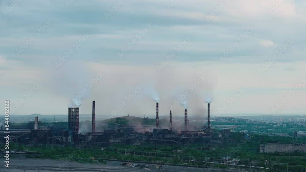 Factory pipes producing dirty smoke clouds. Air pollution concept Factory pipes producing dirty smoke clouds. Air pollution concept