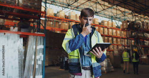 Man, walkie talkie and tablet in factory for communication, orders or check inventory or stock. Male worker, digital technology or contact in shipping company for export, distribution or supply chain