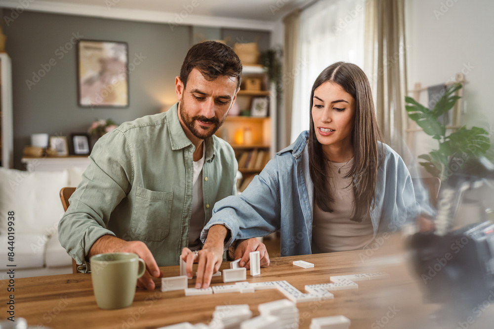 boyfriend and girlfriend play dominoes at home have fun together boyfriend and girlfriend play dominoes at home have fun together