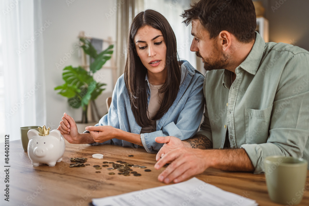 Happy boyfriend and girlfriend save money together in the piggy bank Happy boyfriend and girlfriend save money together in the piggy bank