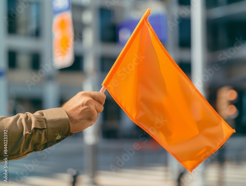 Hand holding traffic flag, Daylight Photography, in direct angle view, cinematic and photorealistic style