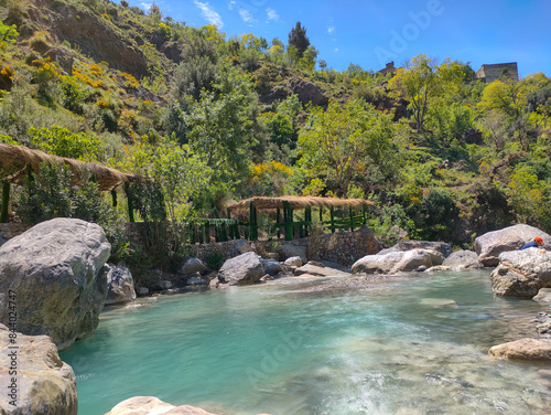 Oued El Bared River and Waterfall, Setif, Algeria. wooden cabins and terraces by the river in Algeria's Sétif province, which is one of its biggest tourist attractions photo