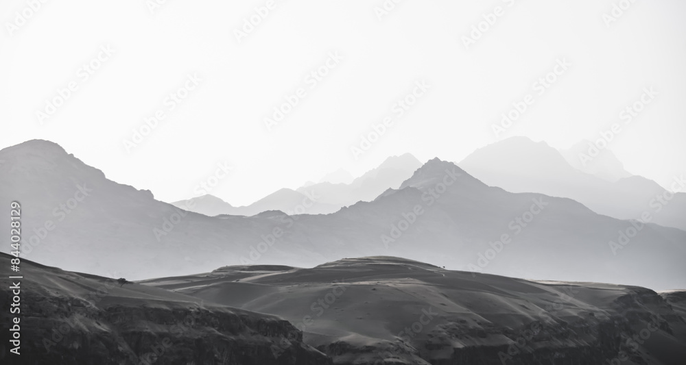 Fototapeta premium Panorama of a mountain range in the morning at dawn, tonal perspective of mountains in the morning haze in the Pamirs in Tajikistan