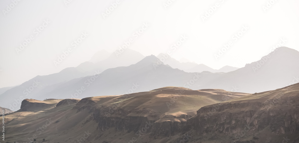 Panorama of a mountain range in the morning at dawn, tonal perspective of mountains in the morning haze in the Pamirs in Tajikistan