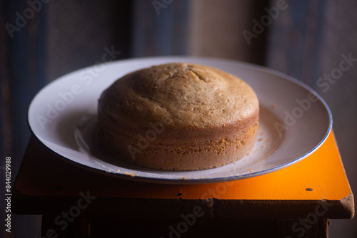 Freshly baked cake on a plate on a stool in a bakery
