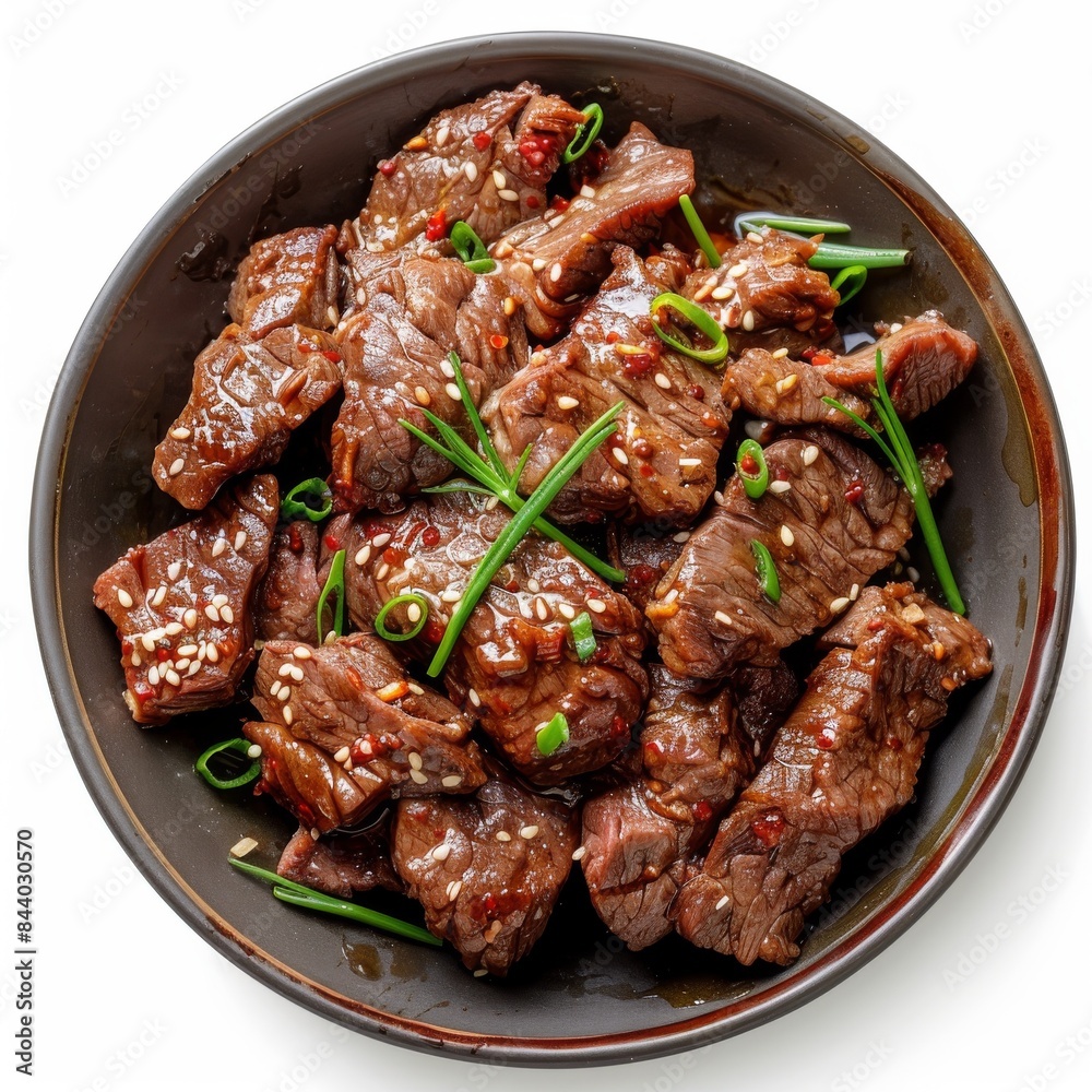 Delicious Sesame Beef Stir Fry With Green Onions and Chili Flakes in a Black Bowl