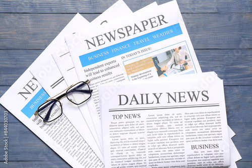 Newspapers with glasses on ...