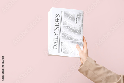 Female hand with daily news...