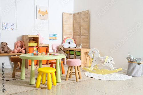 Interior of light playroom with toys in kindergarten