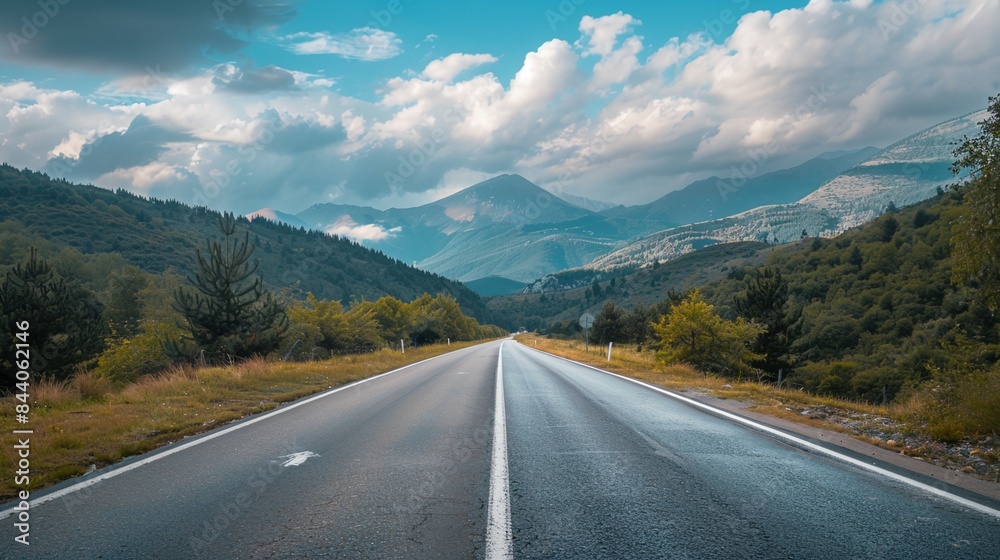 a long road with a mountain range in the background a long road with a mountain range in the background