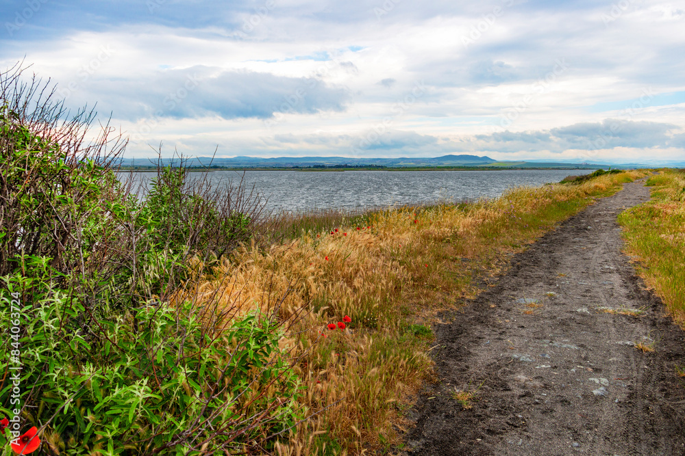 Path through the black sand spit between Lake Pomorie and the Black Sea at Pomorie, Province of Burgas, Bulgaria Path through the black sand spit between Lake Pomorie and the Black Sea at Pomorie, Province of Burgas, Bulgaria